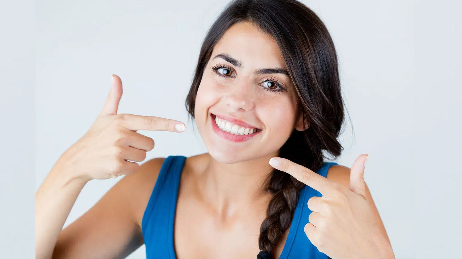 Young woman pointing on her teeth in Chandler, AZ | Smiles of Chandler